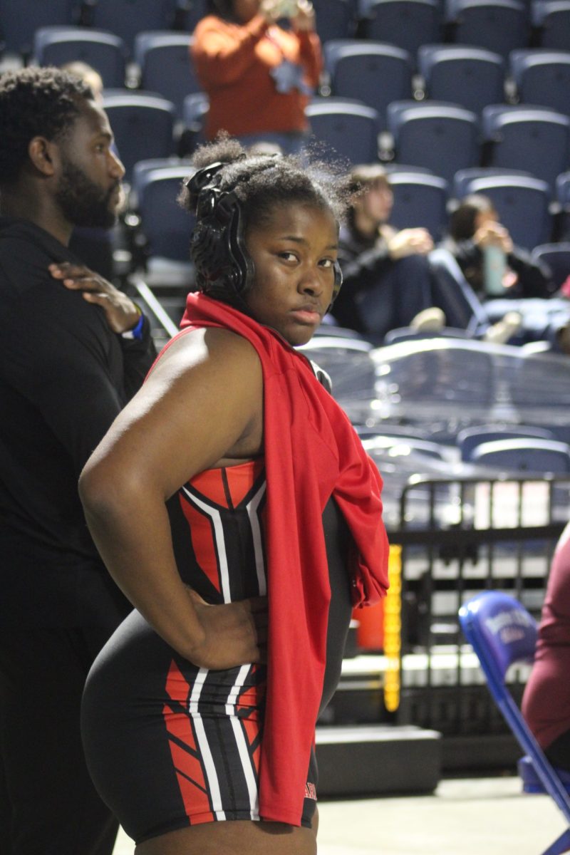 Junior Kate Oguntoyinbo stands during a break at districts. Oguntoyinbo finished in first place in the 18-6A district, allowing her to move on to regionals.