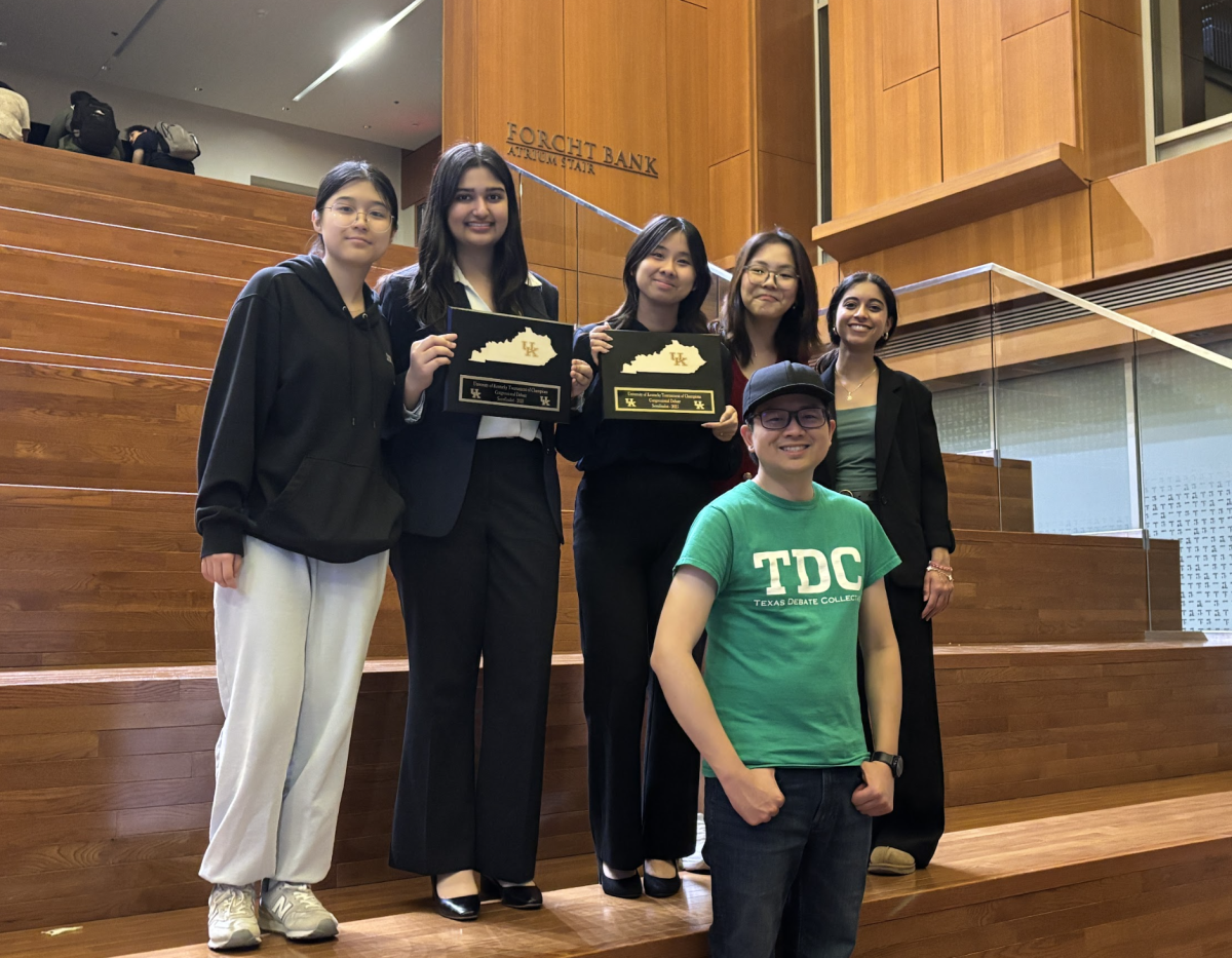 The team takes a group photo at the atrium of the Gatton College of Business and Economics. Hassan and Tran collected their semi-finalist awards after advancing finalists were announced. 