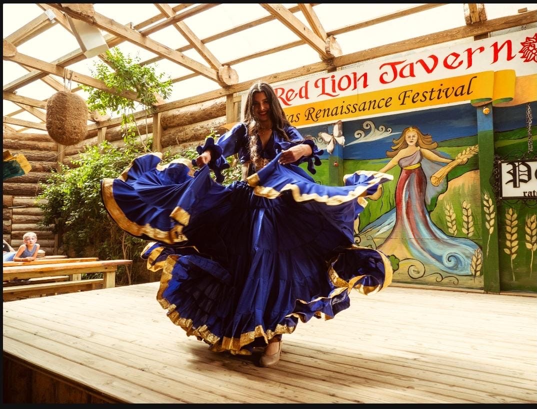 Mangupli wears a blue and gold traditional outfit for the fourth weekend performing at the Renaissance Festival inside the Red Lion tavern. Her smile is big as she takes the stage solo with confidence.
