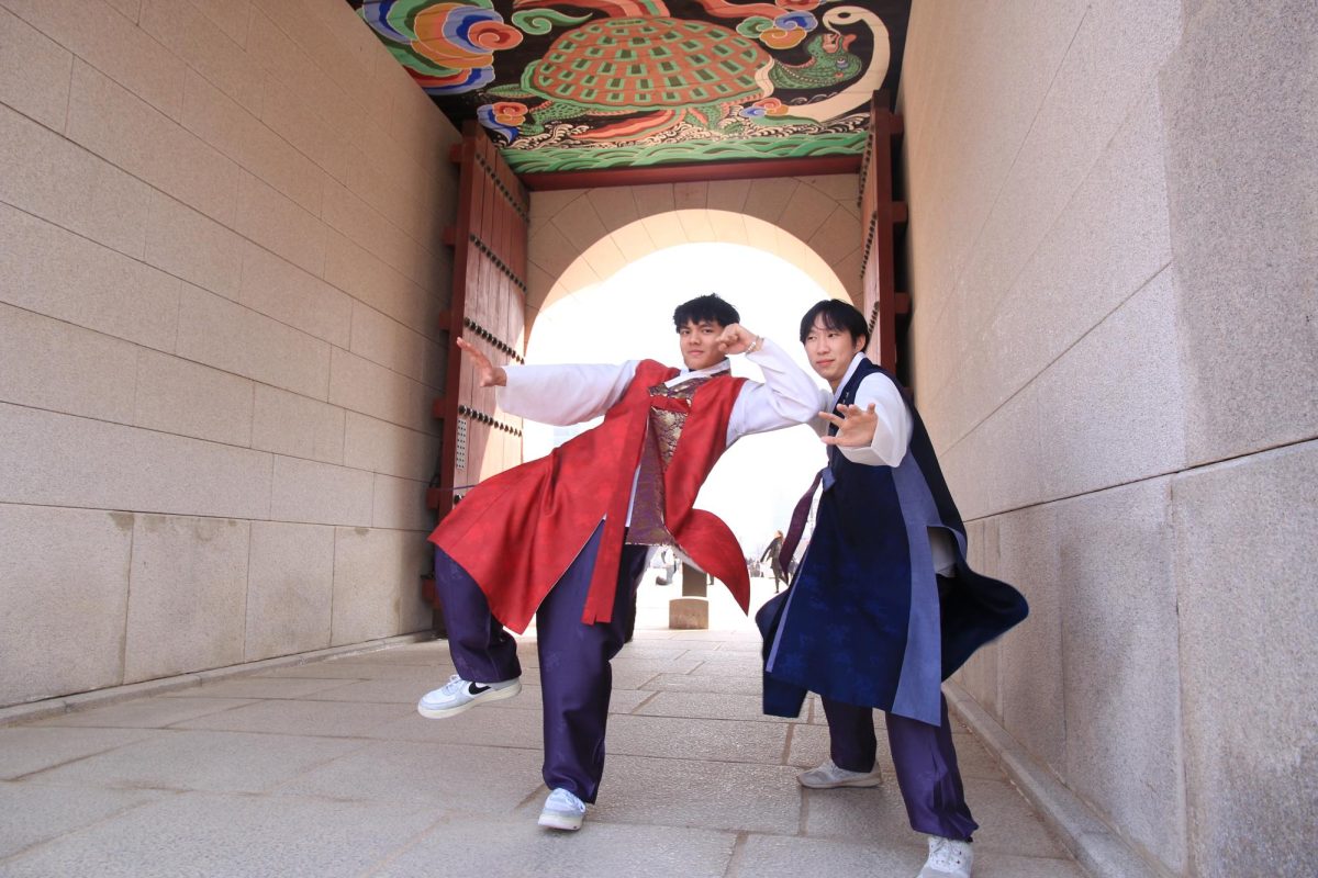 Seniors Darrell Nguyen and Andrew Liu pose in front of the north entrance of the Gyeongbokgung Palace in Seoul. They rented hanboks, traditional Korean clothing, to explore the first royal palace of the Joseon dynasty.
