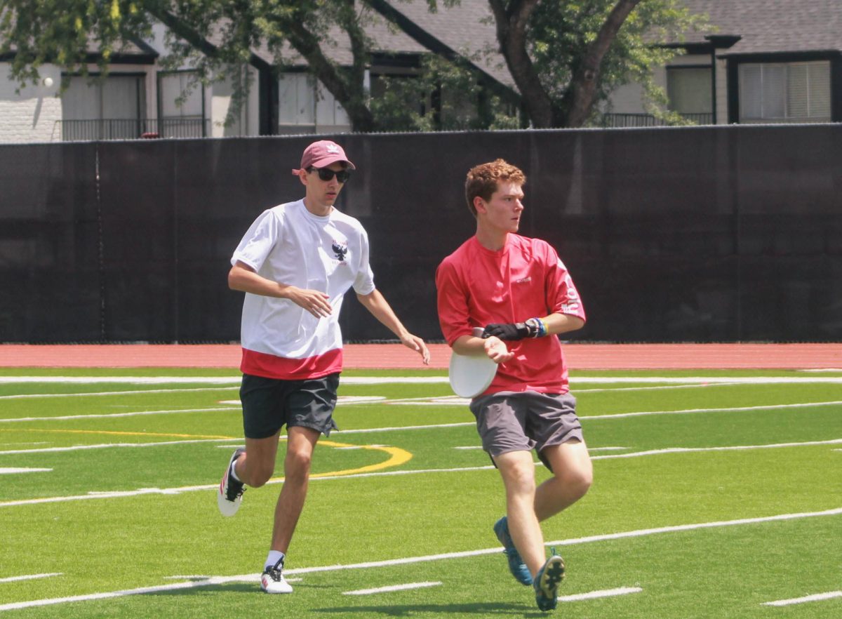 Junior Luke Randall from Energy Institute High School grabs the Frisbee before a player from Thomas High School can get it. Randall acted as a referee in the game as well as a player.