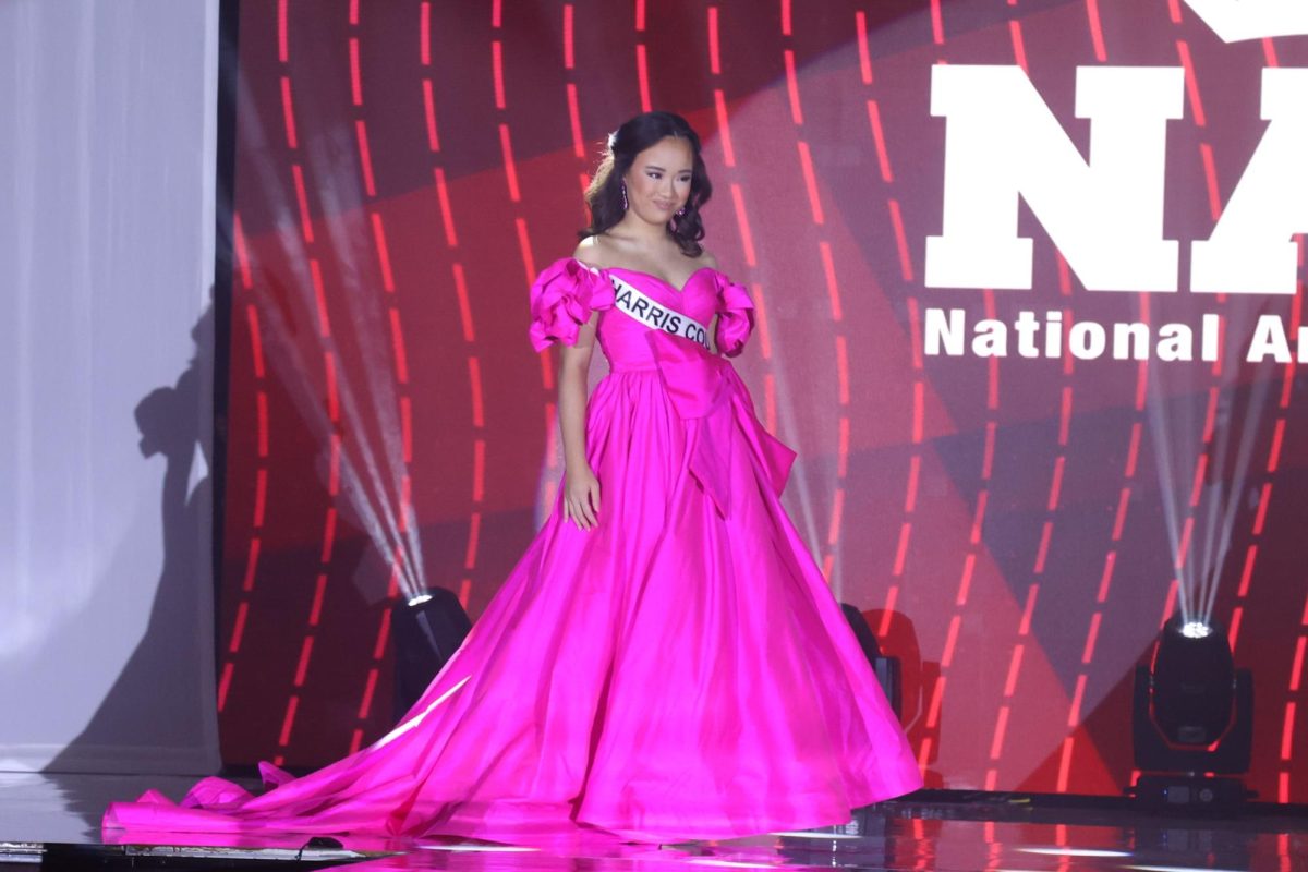 Sun poses for the evening gown competition at the National American Miss pageant. The evening gown competition is one-third of the total contestant’s score.