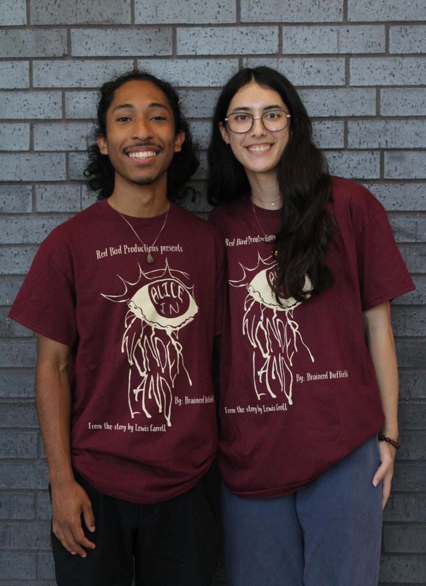 Seniors Daniel Andrade and Emma Kolah wear “Alice in Wonderland” show shirts designed by sophomore and JV actor Sophie Tang, who used the font Alice for all the show's promotional material. Andrade and Kolah directed the Red Bird Productions spring junior varsity show during head theater director Kayla Boffone’s maternity leave.