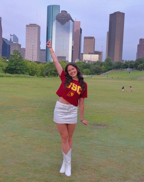 Senior Camila Patino poses at Buffalo Bayou for her senior photos. She wore her college shirt as she will be attending the University of Southern California next year.