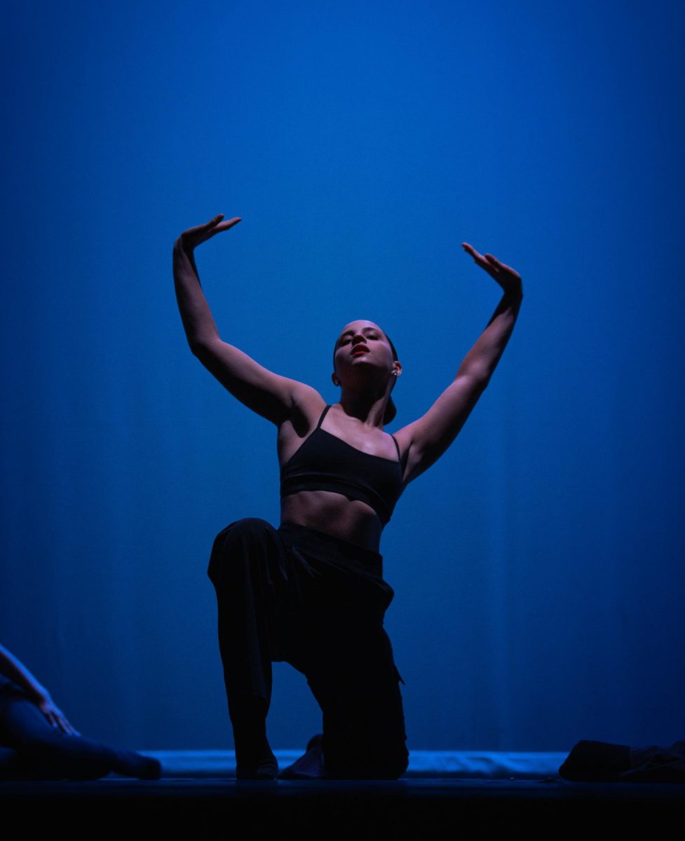 Senior Gaia Giuliani poses as the spotlight gleams down upon her. This show was Giuliani's last in her high school career.