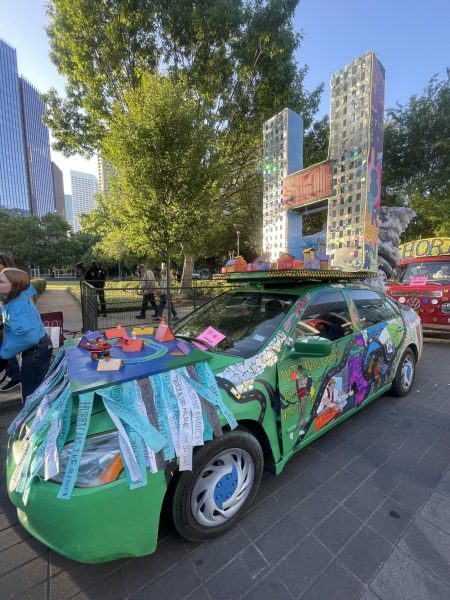 The Bellaire Art Car lines up on the day of the parade, April 12. The 'H' for H-Town reads "Be Someone" and "Houston Strong." 