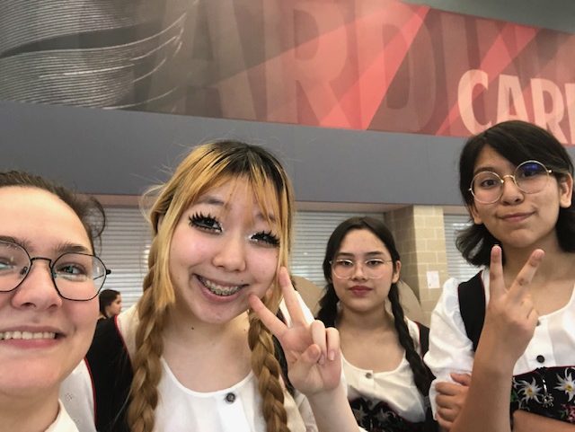 Juniors Quinn Nawotka, Amy Lee, Anna Burns and Alejandra Giron pose for a selfie before their first German BISA performance. Giron performed on the stage only once before this year's German Folk Dance on April 17.