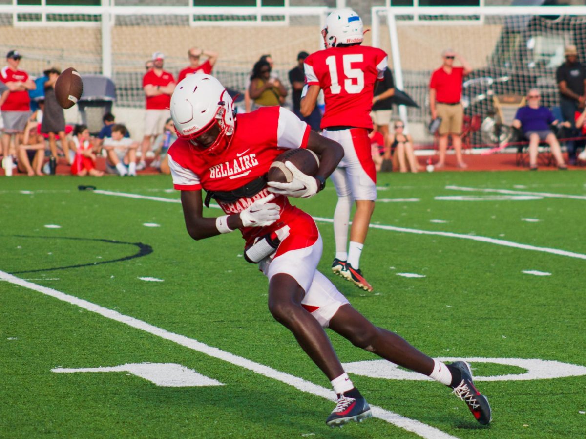 Junior wide receiver Emanuel Kirby runs after a catch from senior quarterback Will Hazen. He advances the play past the 10-yard line.

