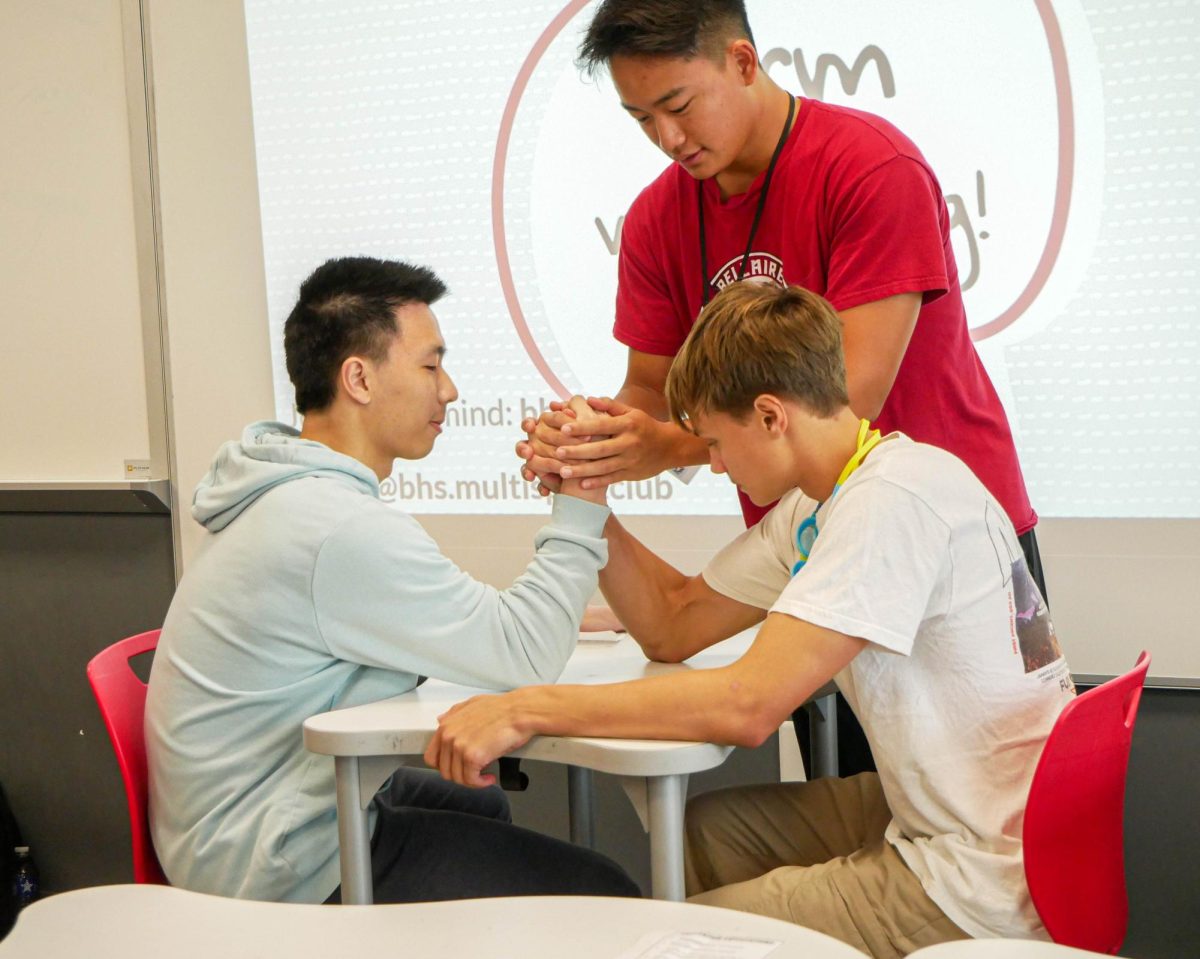 Seniors Jeffrey Guo and Leonid Kolonin prepare to arm wrestle each other in the semifinal match for the boys. Guo won after beating three other competitors and received a goody bag prize.