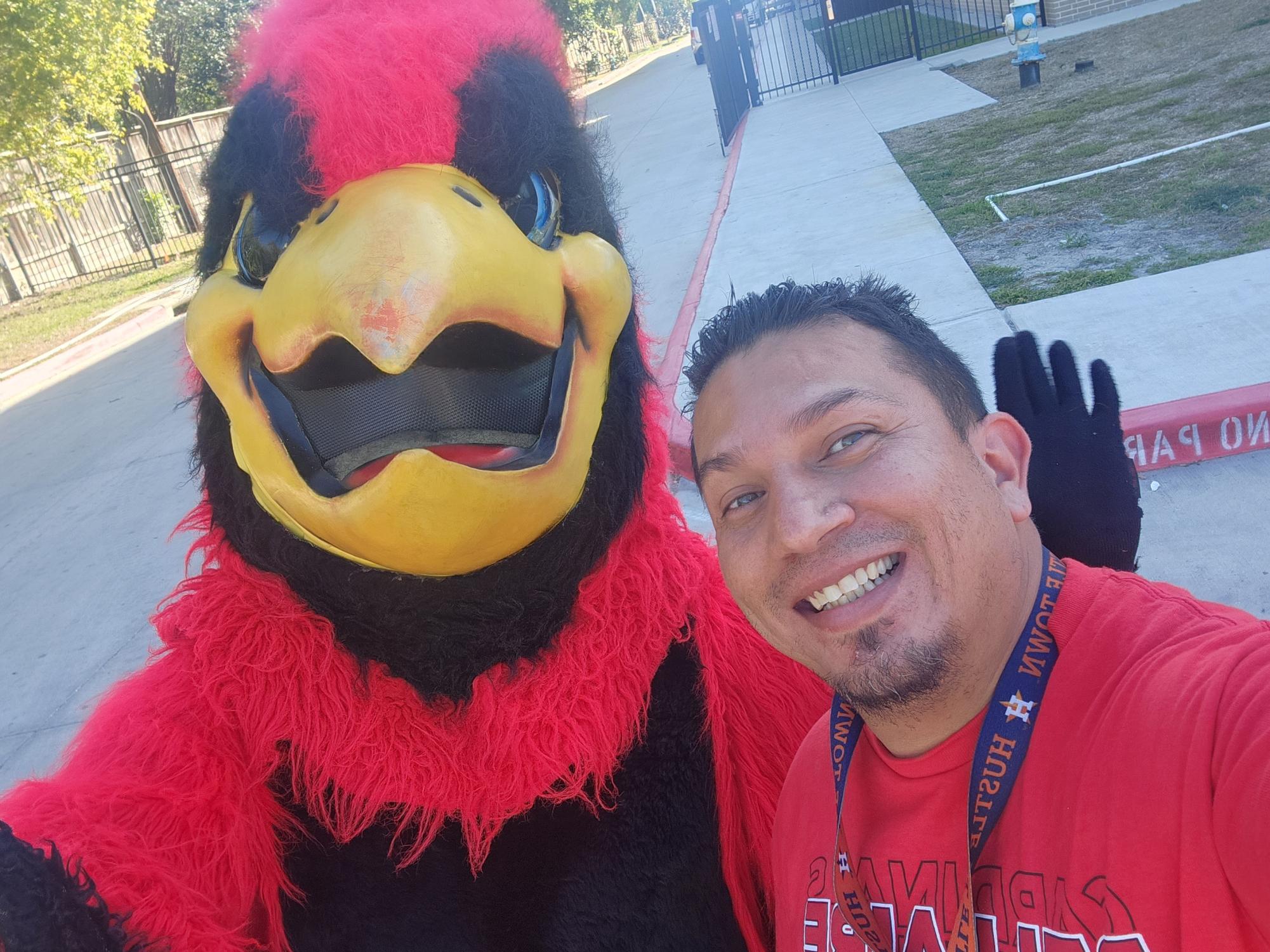 Lopez poses with the Bellaire mascot outside of Bellaire High School. He was on his daily traffic duty.