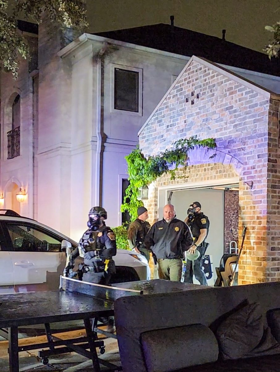 Houston police gather outside of Ella Streeter's house the morning of Halloween, preparing to remove a trespasser. Streeter caught the final glimpses of the scene before seeking refuge in her neighbor ´ s house. 