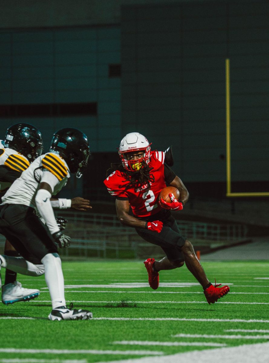 On Sept. 16, the varsity football team lost to Hastings High School. Running back and senior Rydell Nathan dodges Hastings players as he runs across the field.