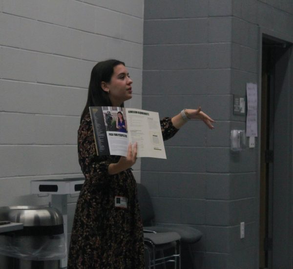 Admissions Representative Isabelle Shaver outlines the admission requirements in the University of Missouri handout. Shaver handed out contact cards, scholarship information, awards booklets and University of Missouri packets to students.