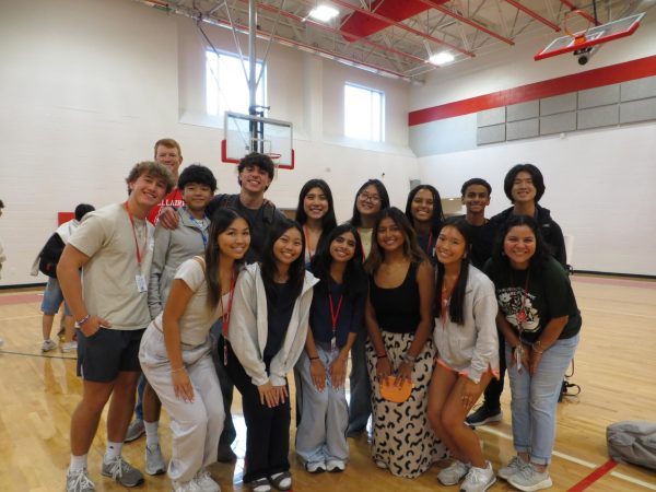 Olivia Leung poses with the Fellowship of Christian Athletes officers. This was FCA's second meeting of the year.