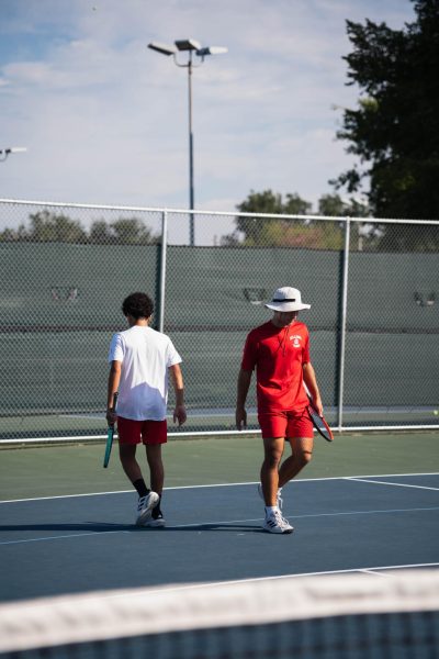 Doubles partners Manuel Catoni and Matthew Burleigh take their positions on the court as they prepare for the next point. The pair competed as line two doubles at the district tournament against Lamar High School.