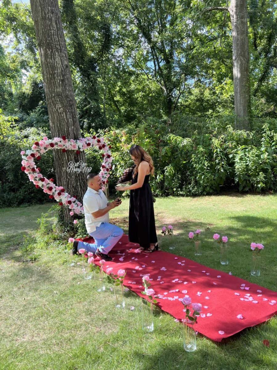 Surrounded by roses, Lopez proposes to Balderas. The couple recently celebrated their 2-year anniversary. 