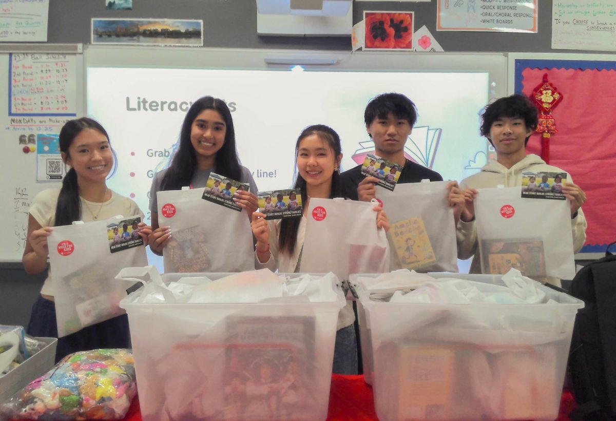 Save the Children’s officers pose with the finished creations. They met their goal of 70 kits. 
