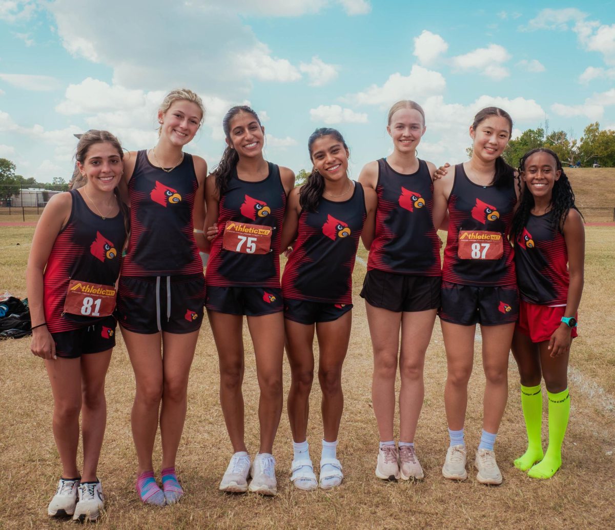 The girls’ varsity cross-country team smiles for a photo before their 5000 meter district race. Senior Sophia Hamdani was “so proud” of the team's meet performance.