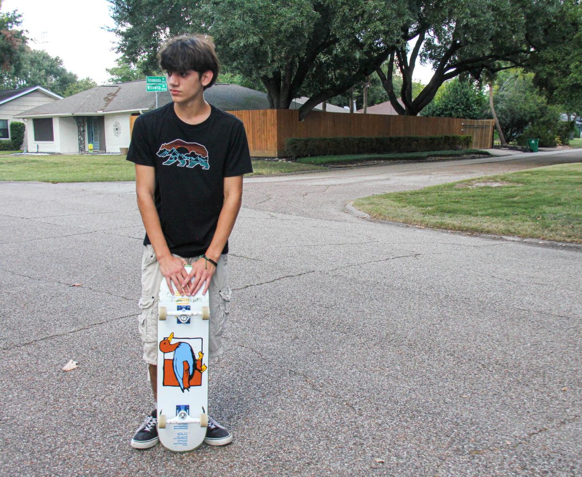 Junior Alessandro Nardi poses with his Lucky Duck Death Wish skateboard. Nardi custom-made the board with his girlfriend over the summer.