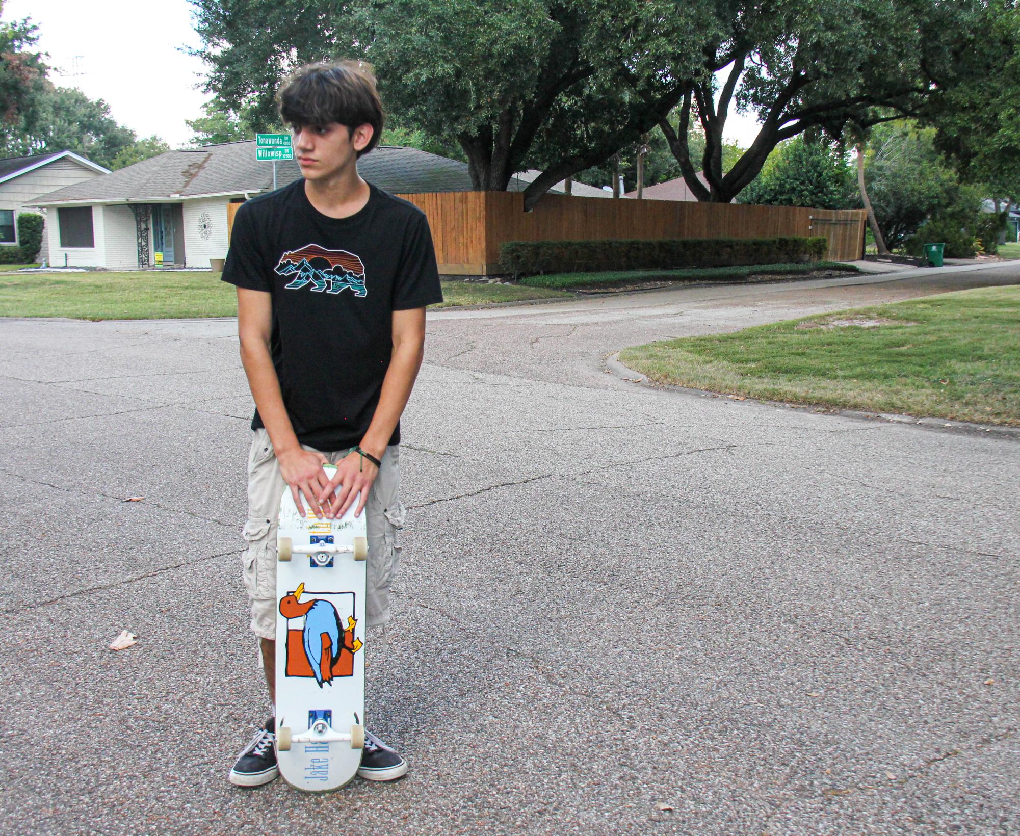 Junior Alessandro Nardi poses with his Lucky Duck Death Wish skateboard. Nardi custom-made the board with his girlfriend over the summer.