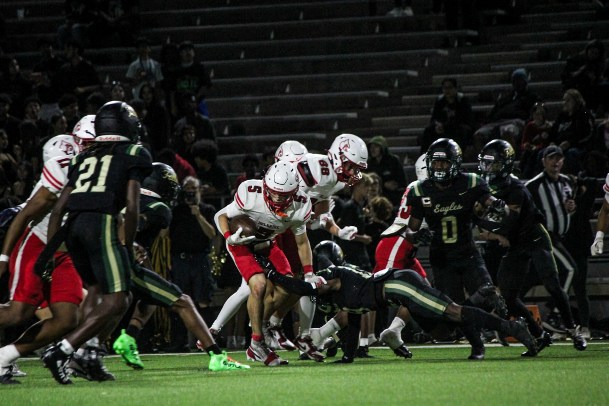 Senior running back Chance Diebner rushes the ball forward after receiving a handoff. He attempts to get the Cardinals a first down.
