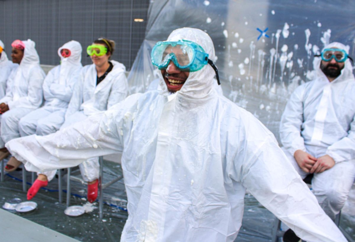 Safety Manager Oscar Lopez laughs as a student attempts to pie him in the face. The Parent-Teacher Organization (PTO) hosted a pie-throwing fundraiser and gave students an opportunity to pie participating teachers and administrators during Cardinal Hour on Nov. 18. 