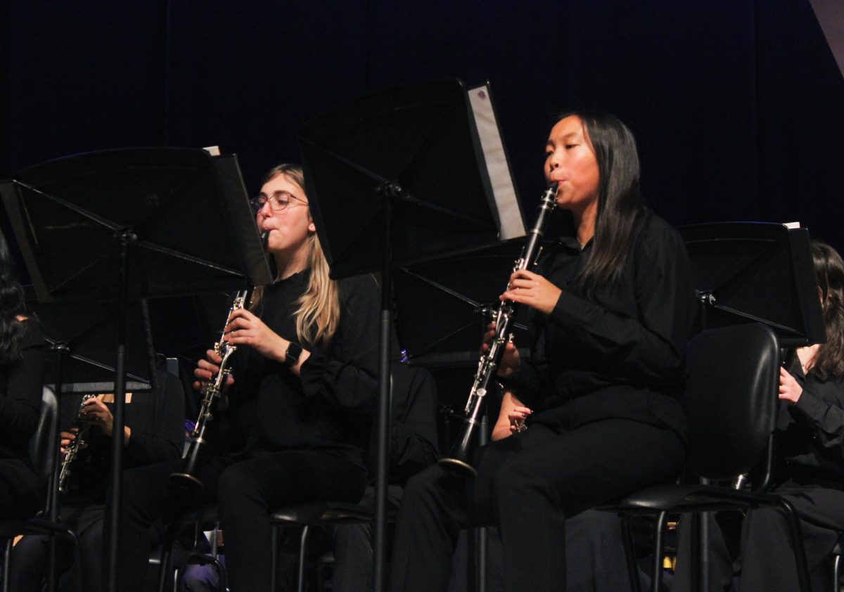 Junior Sierra Little and senior Meadow Lam lead the clarinet section in the band concert on Nov. 20.