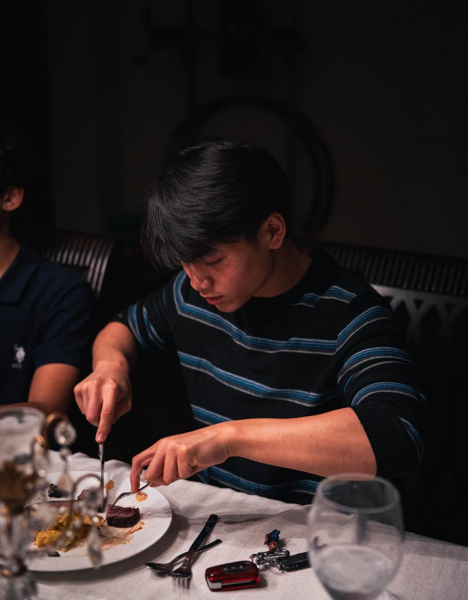 A guest at the banquet slices a piece of the ponzu-glazed marinated boneless short rib. The boneless short rib was a last-minute addition added the first day of prep, since it was significantly cheaper than other steaks while being of better quality.