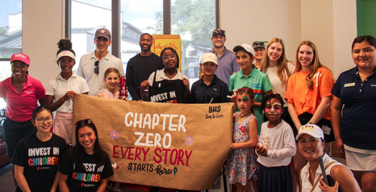 Both clubs join together for a picture with the banner made by STC (Save the Children). Girls Golf LPG participated in their Literacy Kit Distribution Event. 