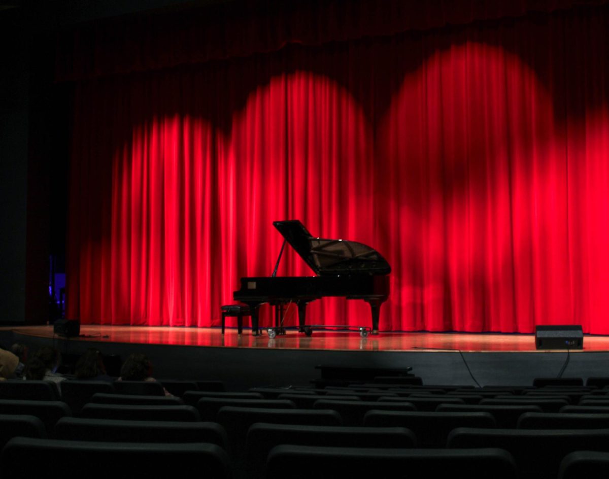 The auditorium lights brighten the piano on the stage where the performers would play their pieces. In total, 32 pieces were performed to the audience at the recital.
