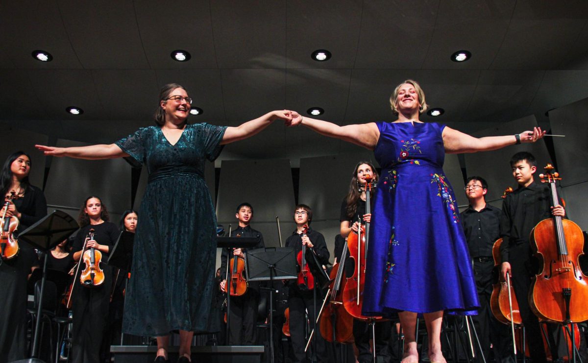 Orchestra Director Laurette Reynosa and Choir Director Amy Solberg bow at the end of the Winter Concert. This was their 21st year doing the concert.