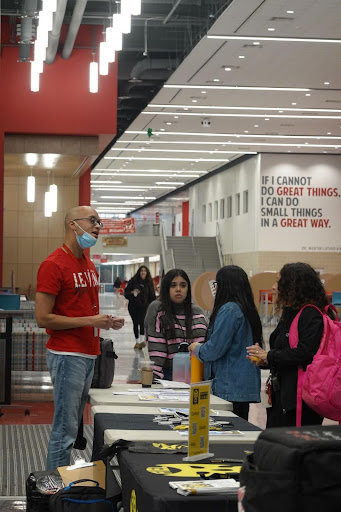 ESL teacher Gregory Gaylor talks to students and parents. This event, designed by the counselor department, hosted a variety of booth participants, such as trade schools and community colleges.