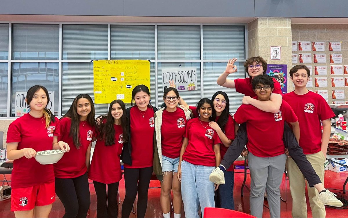 The concessions team takes a quick break before selling dinner on Saturday. This was senior Joy Xia’s (fourth from left) second year of being the section leader for concessions.  