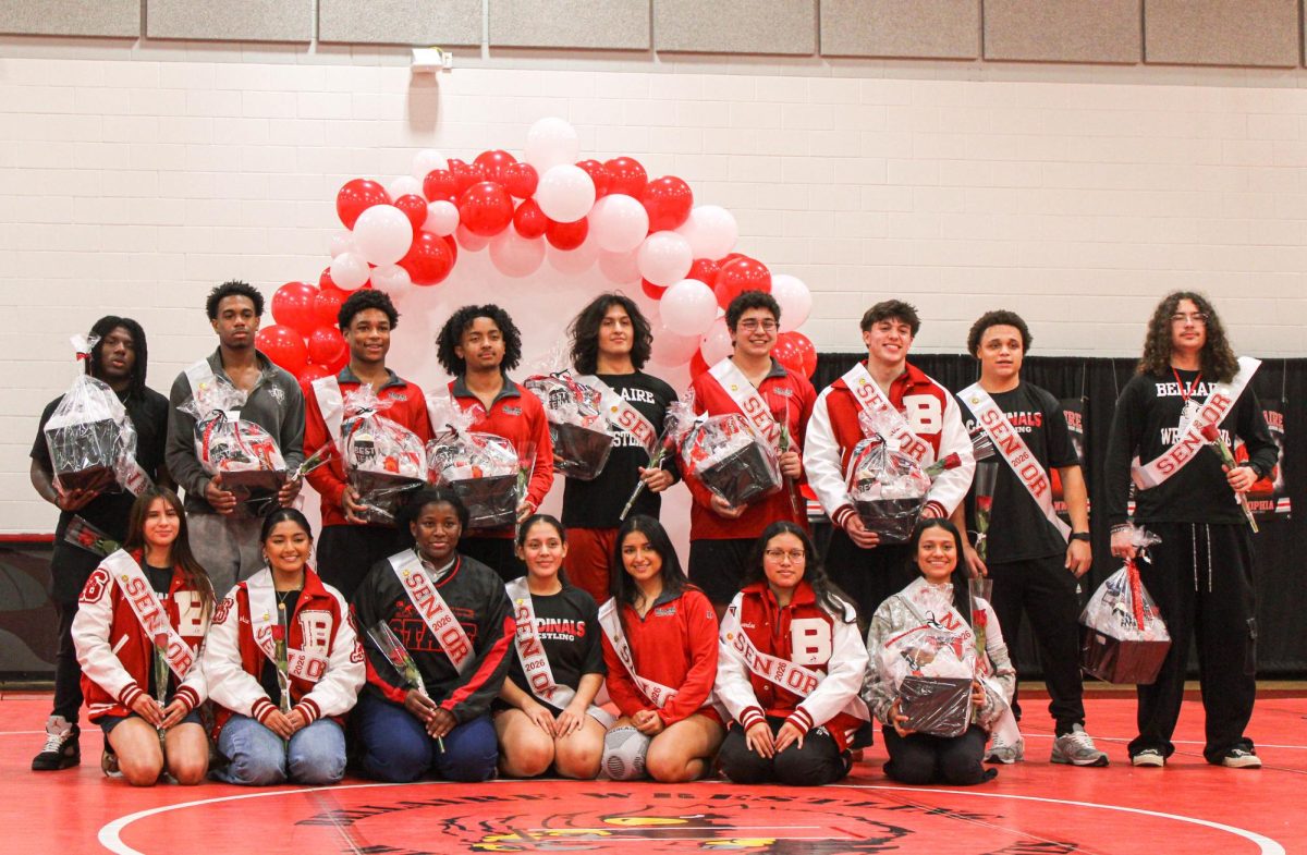 Senior wrestlers pose with gift baskets and roses before the meet. The Thunderdome tournament doubled as senior night, which was organized by senior Sophia Martinez, who’s been wrestling for 5 years. 