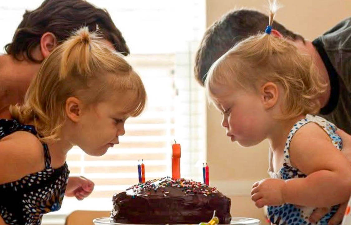 Fraternal twins Ellie Apple and Jane Apple blow the candles out on the cake together. They were celebrating their second birthday.