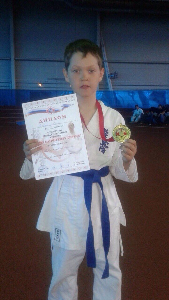 Junior Alim Garipov presents a medal he won in karate as a child in Russia. Garipov did karate as a kid from ages 5-12, until a leg injury prevented him from continuing.