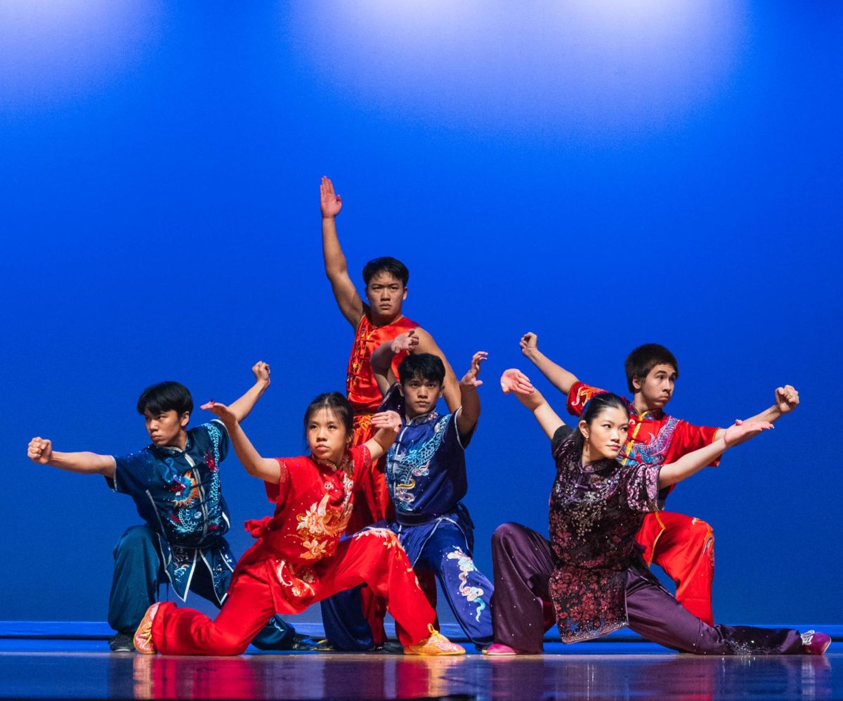 Sophomores Aldric Tanzil and Audrey Li, seniors Austin Byun and Avery Tanzil, junior Elaine Wang and sophomore Alexander Starnes pose together at the end of the Gongfu performance. The members each performed using their specialty weapon, including the broadsword, nine section whip, staff and monk's spade. 
