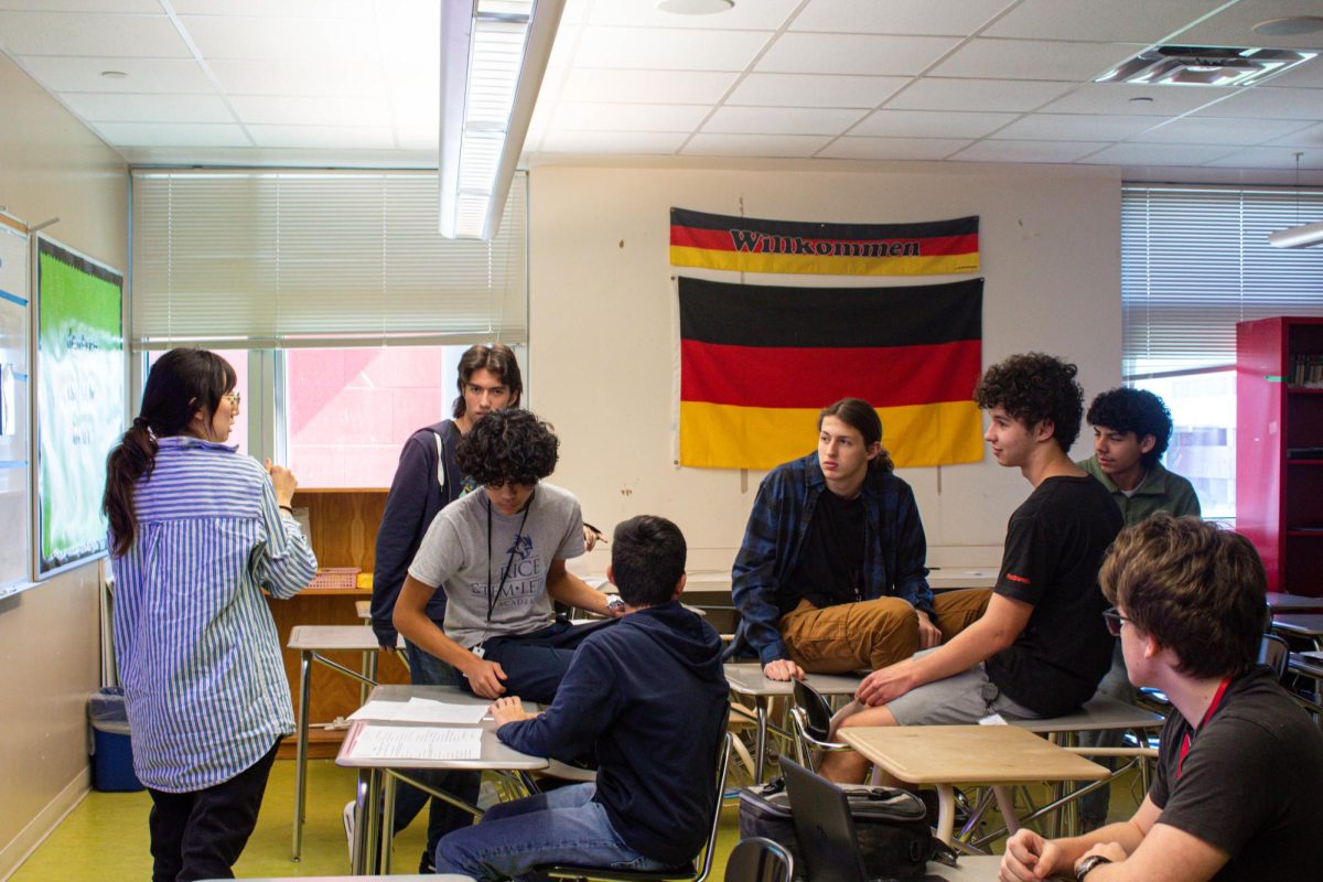 Head of the German department Hannah Henry guides students through her feedback as they fine-tune parts of their skit. She helped them adjust the timing and structure leading up to competition day.