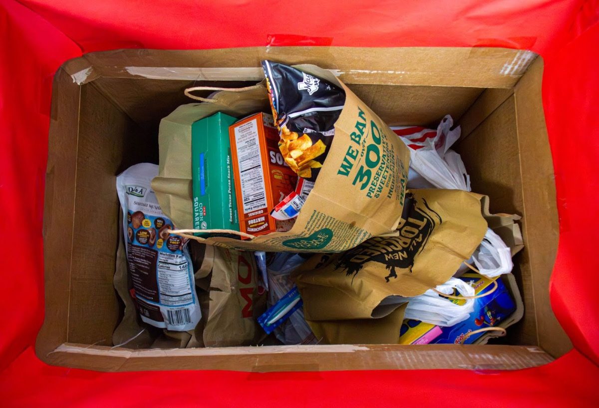 Bags of food items fill the donation box used for the Souper Bowl of Caring food drive. This box was placed in the front office and was decorated by Aguilar.