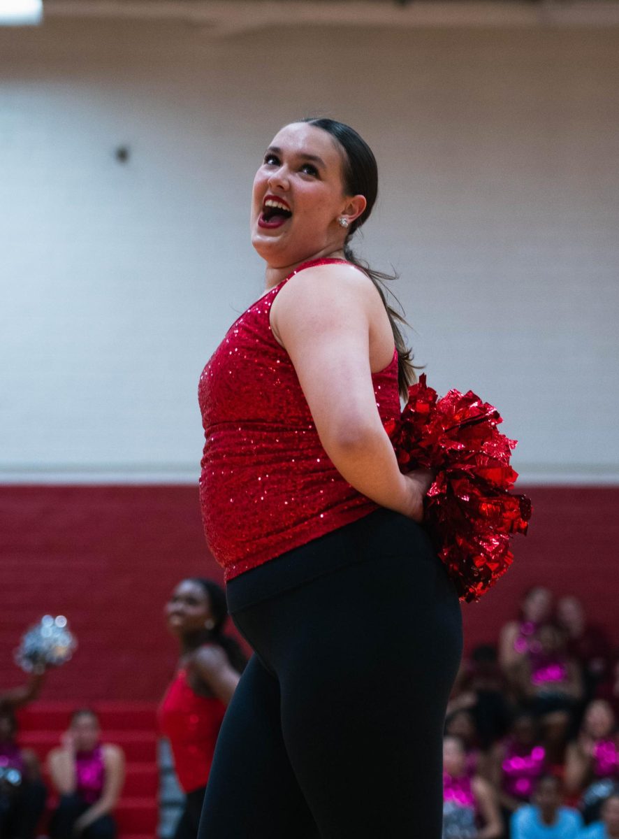 Sophomore Kate Dholakia counts steps while the junior varsity dancers enter the dance floor during the large pom ensemble, 'Fireball.' The junior varsity Belles took home first place for this number in the' Junior Varsity pom' category.