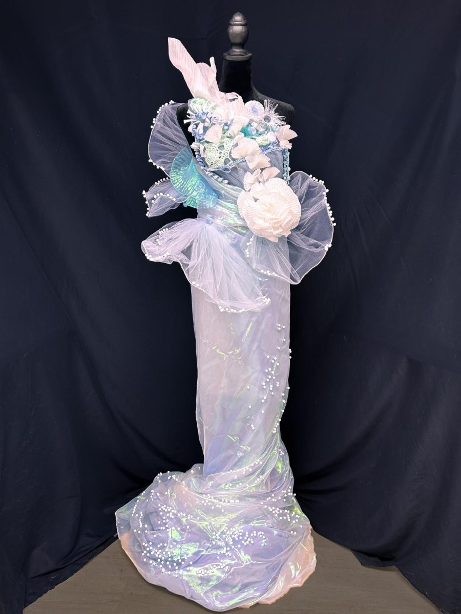 Zheng uses crocheted yarn, folded paper, mesh, and plastic bottles within her piece. She went through many variations of the design before she decided on the final dress.
