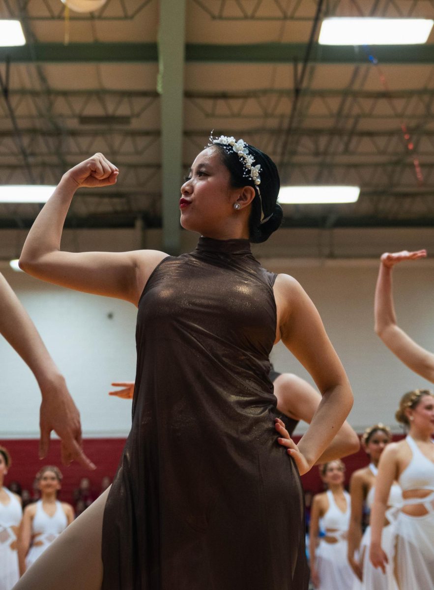 Senior Julie Tang strikes a pose during the large novelty ensemble, "Muses." This dance number included music from the movie ‘Hercules.'