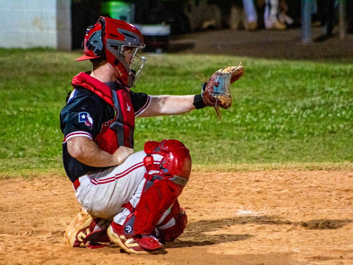 Junior catcher Sully Mulcahy gets ready to catch while playing defense. Mulcahy has been on the varsity team since his freshman year and also plays first base.
