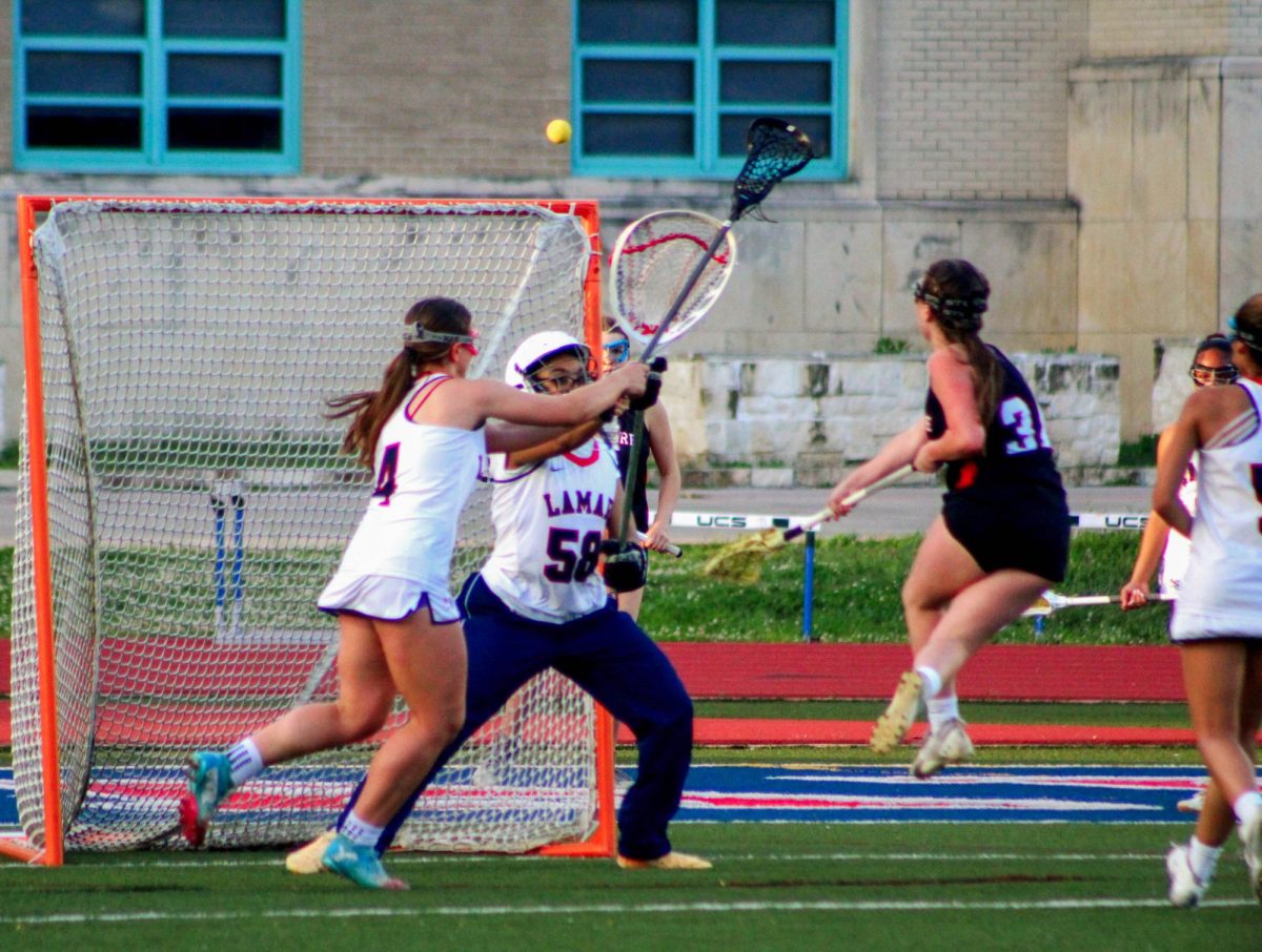 Senior attacker Jane Apple jumps to shoot a goal after catching the ball. Apple was one of the three varsity captains this year.