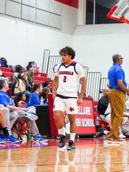 During Bellaire’s non-conference game against Episcopal, senior and point guard Micah Joseph walks down the court while the opposing team shoots free throws. Joseph has been playing under Coach Glover for two years.