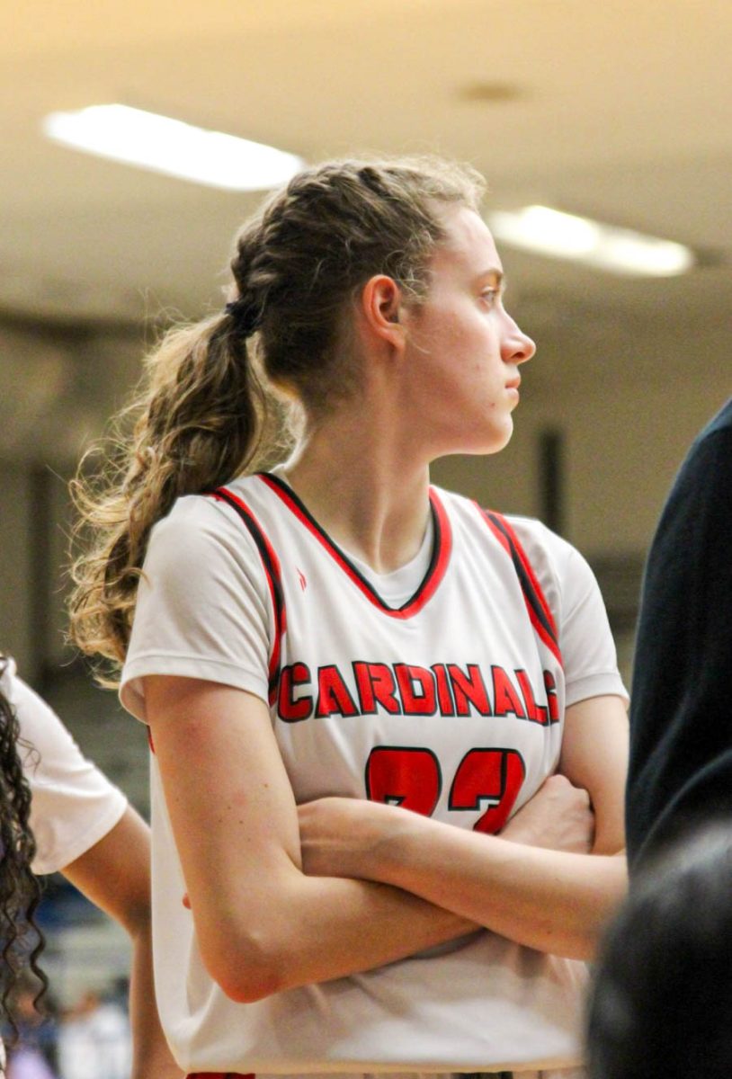 Senior Maisie Moncrief looks out at the court during a basketball game. Moncrief played three sports at Bellaire, track, volleyball and basketball, but started basketball the earliest.