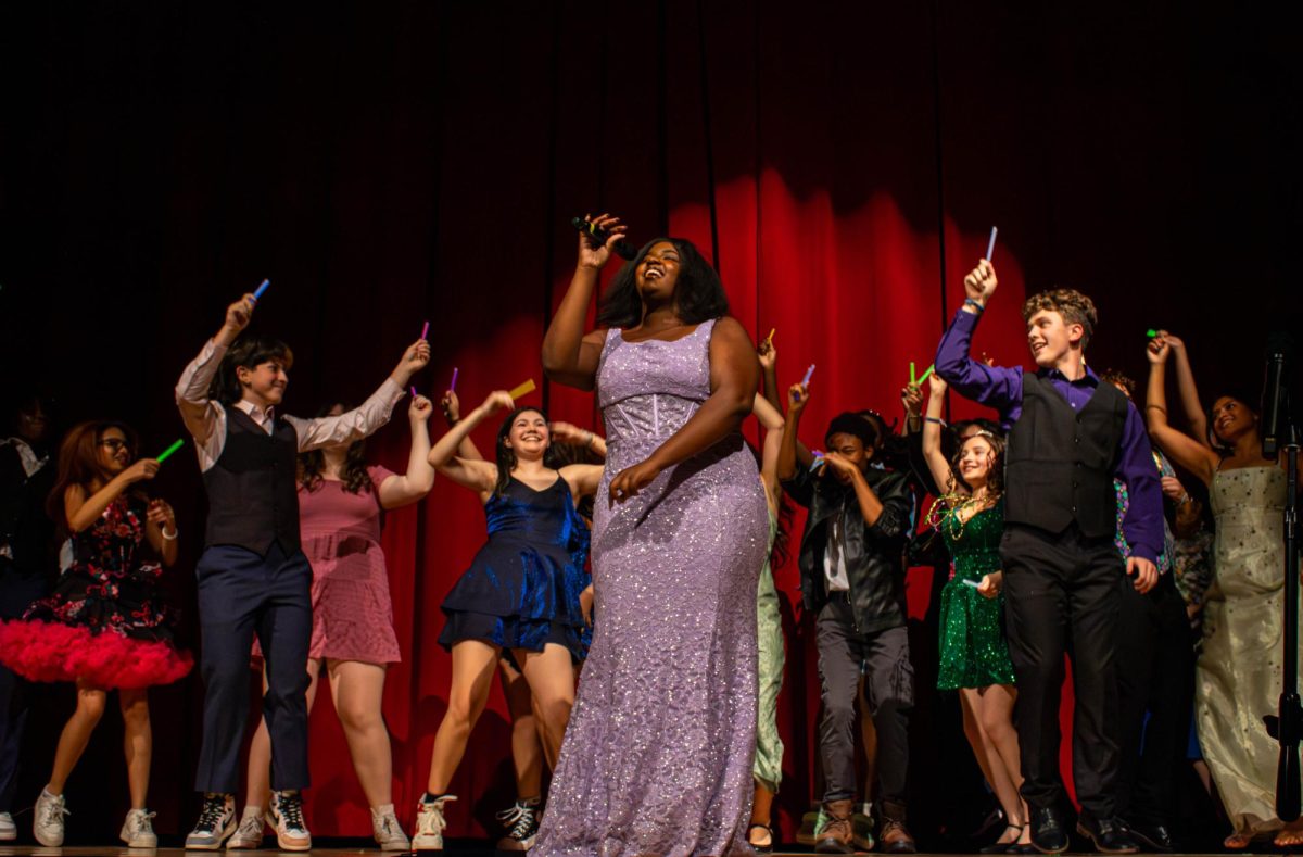 Students circle around and hype up senior Emmerie Napier as she sings "Golden" by HUNTR/X. Napier has been in choir for four years and serves as the vice president of Concert Chorale and soprano two section leader. 