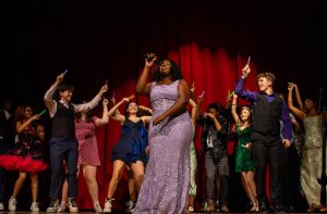 Students circle around and hype up senior Emmerie Napier as she sings "Golden" by HUNTR/X. Napier has been in choir for four years and serves as the vice president of Concert Chorale and soprano two section leader.