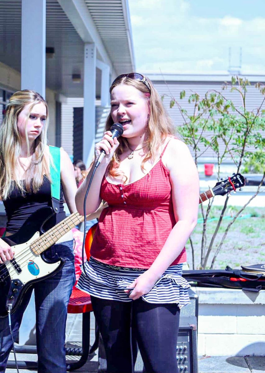 Bradley sings at a rooftop concert in collaboration with Rooftop Garden Club. These performances and ones during lunch was how the Tiger and the Lilies were able to play together after the talent show.