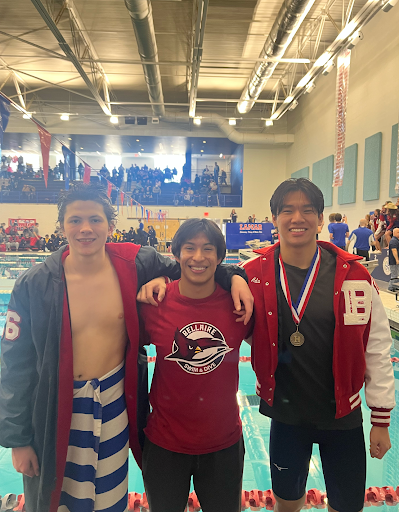 (From left to right) Lamar senior John Doneker, senior Paul Pichon-Garcia, and Zhao replicate a photo they took at a swim meet in middle school at the 2026 District Championship meet. Zhao describes it as “a full circle moment.”